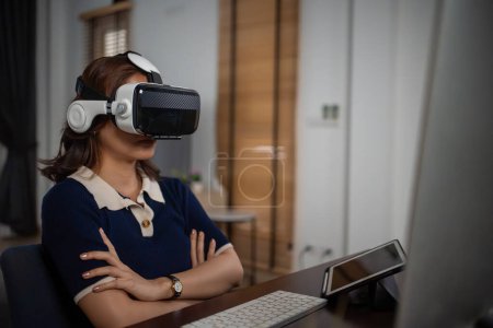 Photo for Futuristic women Engineer Wearing Virtual Reality Glasses working with a futuristic hologram to analysis and create alternative energy solutions with wind turbines - Royalty Free Image