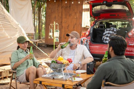 Photo for Group tourists drinking beer-alcohol and play guitar together with enjoy and happiness in Summer while camping - Royalty Free Image