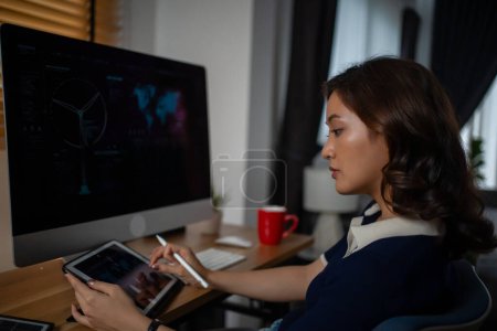 Photo for Futuristic women Engineer working with Holographic Augmented Reality and 3D Wind Turbine Model on computer and tablet at home office ,Concept of technology and environment - Royalty Free Image