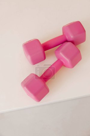 Photo for Two pink dumbbells on white background - Royalty Free Image