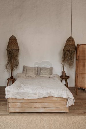 Photo for White simple wabi sabi bedroom design with woven lamps and comfortable bed with white sheets, real photo - Royalty Free Image