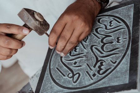 Photo for Crafting an Islamic verse on a marble slate by an artist in Pakistan - Royalty Free Image