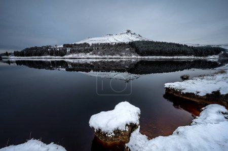 Photo for Snowcapped hills reflection in Dovestone Reservoir near greater Manchester UK - Royalty Free Image