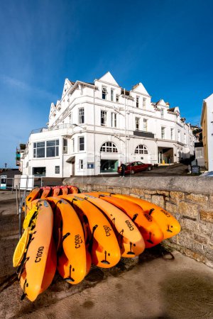 Téléchargez les photos : Kayaks alignés devant un bâtiment blanc à Cornwall, Royaume-Uni - en image libre de droit