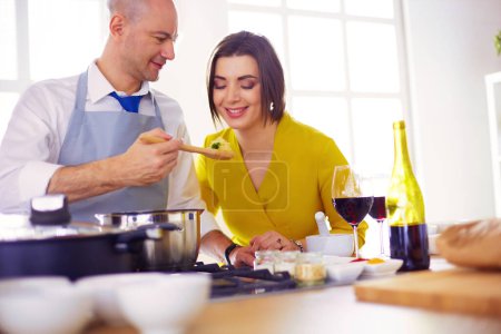 Photo for Couple cooking together in the kitchen at home. - Royalty Free Image