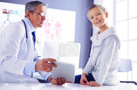 Photo for Portrait of a cute little girl and her doctor at hospital. - Royalty Free Image