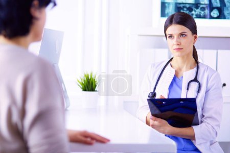 Photo for Medical consultation in a hospital. Doctor listening to a patients problems - Royalty Free Image