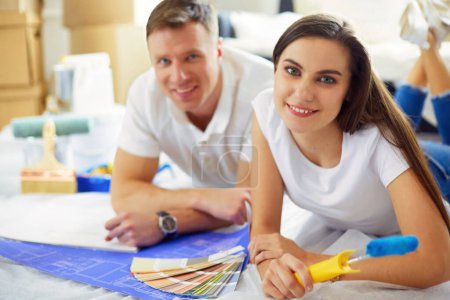 Photo for Young couple choosing colors of their new flat. - Royalty Free Image