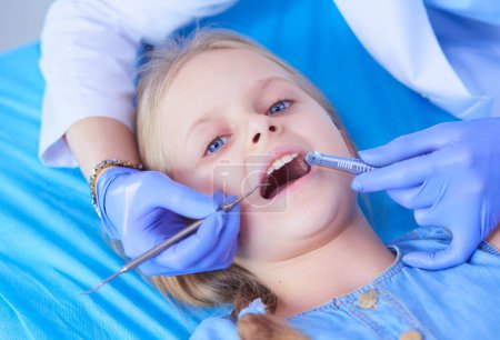 Photo for Little girl sitting in the dentists office - Royalty Free Image