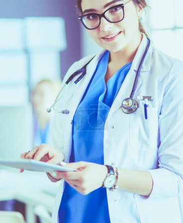 Photo for Female doctor using tablet computer in hospital lobby, - Royalty Free Image