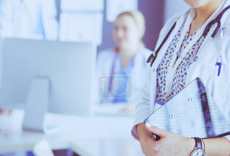 Photo for Woman doctor standing with stethoscope at hospital. - Royalty Free Image