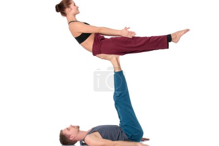 Photo for Young athletic couple practicing acroyoga. Balancing in pair. - Royalty Free Image