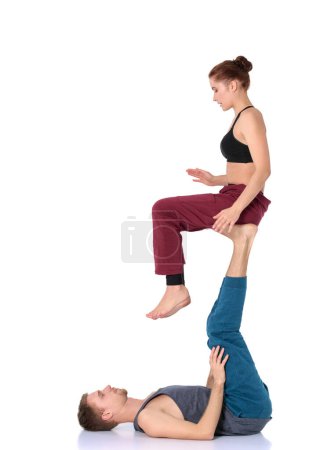 Photo for Young athletic couple practicing acroyoga. Balancing in pair. - Royalty Free Image