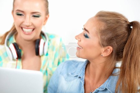 Photo for Two young women sitting with laptop and credit cart - Royalty Free Image