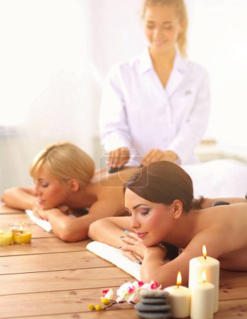 Photo for Two young beautiful women relaxing and enjoying at the spa - Royalty Free Image