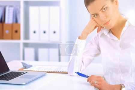 Photo for Attractive businesswoman sitting with laptop in the office - Royalty Free Image