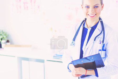 Photo for Smiling female doctor with a folder in uniform standing. - Royalty Free Image