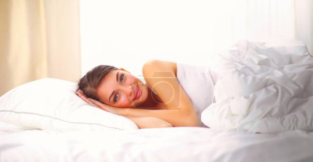 Photo for Beautiful girl sleeps in the bedroom, lying on bed. - Royalty Free Image