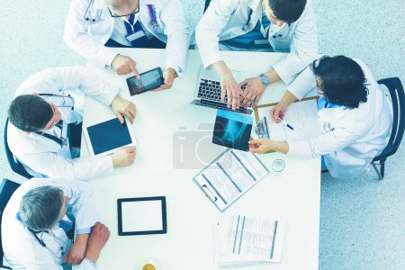 Photo for Medical team sitting and discussing at table, top view. - Royalty Free Image