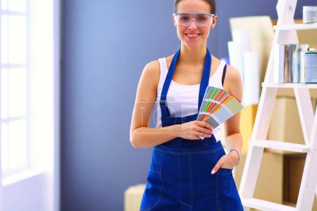 Photo for Happy beautiful young woman doing wall painting - Royalty Free Image