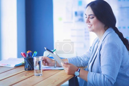 Photo for Pretty young female manager using modern digital tablet at office - Royalty Free Image