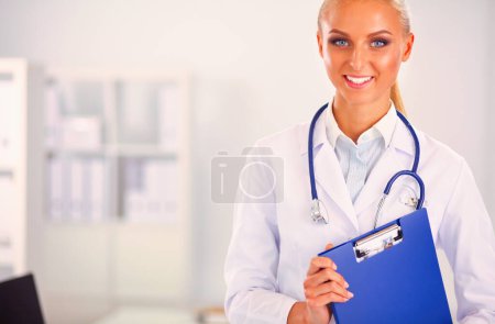Photo for Woman doctor standing with folder at hospital. - Royalty Free Image