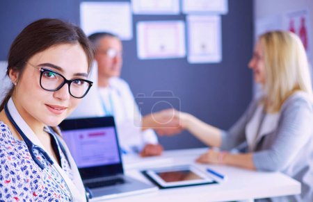 Photo for Doctor and patient discussing something while sitting at the table . Medicine and health care concept. - Royalty Free Image