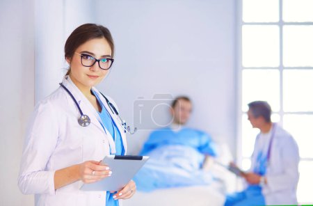 Foto de Médico femenino usando tableta en el vestíbulo del hospital, - Imagen libre de derechos