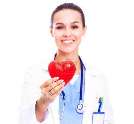 Photo for Positive female doctor standing with stethoscope and red heart symbol. - Royalty Free Image