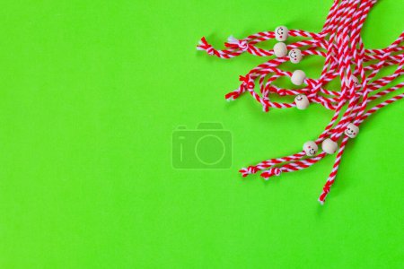 Photo for Many Bulgarian symbol of spring white and red martenitsa on green background - Royalty Free Image