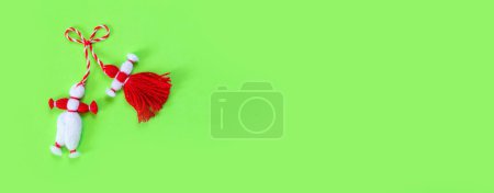 Photo for Bulgarian symbol of spring white and red martenitsa on green banner background - Royalty Free Image