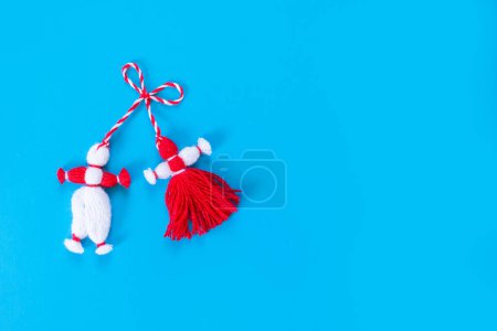 Photo for Bulgarian symbol of spring white and red martenitsa on blue background - Royalty Free Image