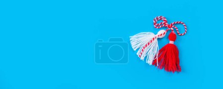 Photo for Bulgarian symbol of spring, many white and red martenitsa on blue banner background - Royalty Free Image