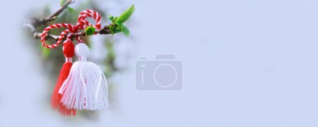 Photo for Bulgarian Martenitsa spring sign on the tree branch holiday banner background - Royalty Free Image
