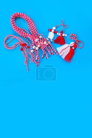Photo for Bulgarian symbols of spring, many different white and red martenitsa on blue background - Royalty Free Image