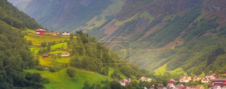 Norwegian sunset village banner landscape, mountains and colorful houses, Norway, Flam