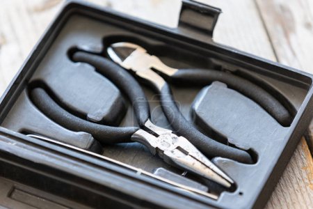 Needle nose pliers and wire cutter or flush nippers professional tools in plastic box