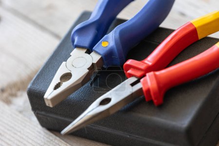 Needle nose pliers, professional tools for metal construction. Mechanic instrument for repairing works, close-up