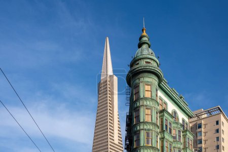 Photo for From below Columbus Tower and Transamerica Pyramid against blue sky in San Francisco - Royalty Free Image