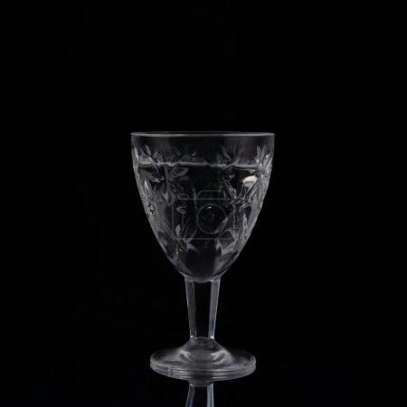 vintage crystal shot glass of vodka on black background.