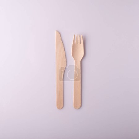 wooden knife and fork disposable eco-friendly tableware on a white background.