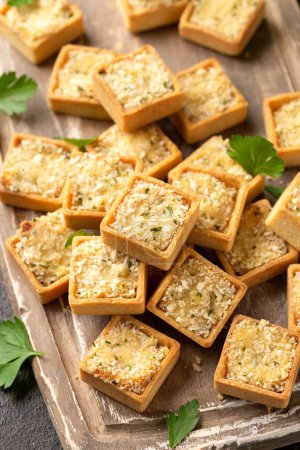 Photo for Shortcrust pastry Mini fish pies filled with cod and salmon in a creamy sauce topped with a parsley breadcrumb. - Royalty Free Image