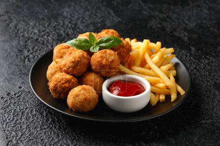 Foto de Mini Chicken kiev breast with french fries and ketchup. - Imagen libre de derechos