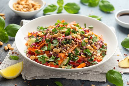 Téléchargez les photos : Salade de quinoa asiatiques aux légumes frais, arachides et herbes. Aliments sains - en image libre de droit