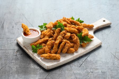 Photo for Crispy Shredded Chicken with sweet chilli sauce on white wooden board. - Royalty Free Image