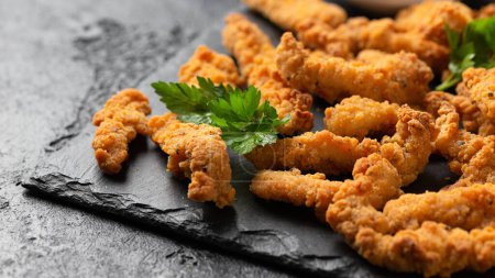Photo for Crispy Shredded Chicken with sweet chilli sauce served on black slate. Party finger food snack concept. - Royalty Free Image