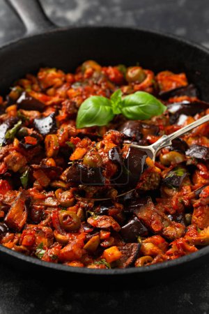Photo for Sicilian Eggplant, Aubergine caponata in iron cast pan. - Royalty Free Image