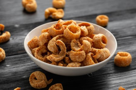 Photo for Crispy Pork crackling, scratchings. deep fries in white bowl. - Royalty Free Image