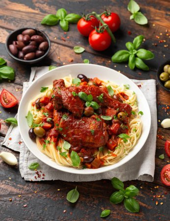 Photo for Cacciatore Chicken with spaghetti, vegetables, olives and tomatoes. - Royalty Free Image