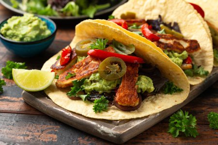 Photo for Fried halloumi fajitas with pan roasted onions and bell peppers, avocado guacamole and pickled jalapeno peppers. - Royalty Free Image